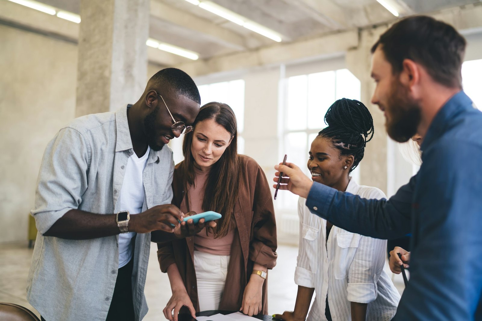 Happy diverse colleagues brainstorming in office