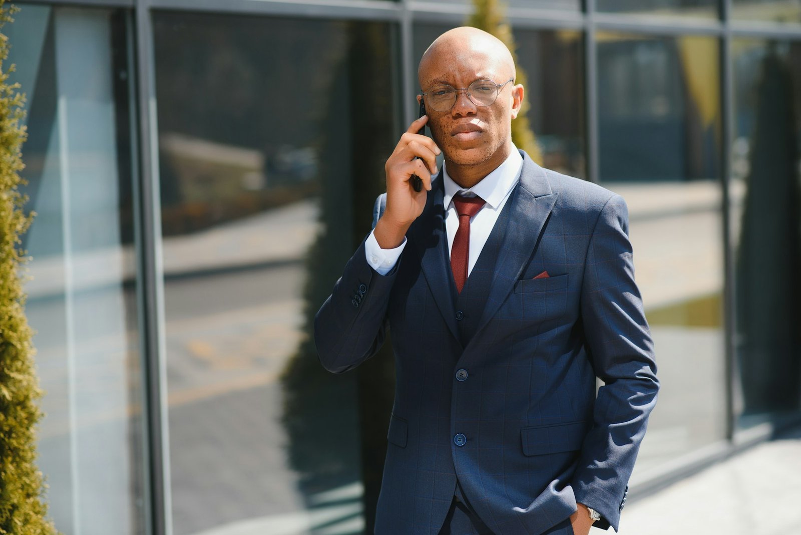 Portrait of african business executive walking and talking on cell phone